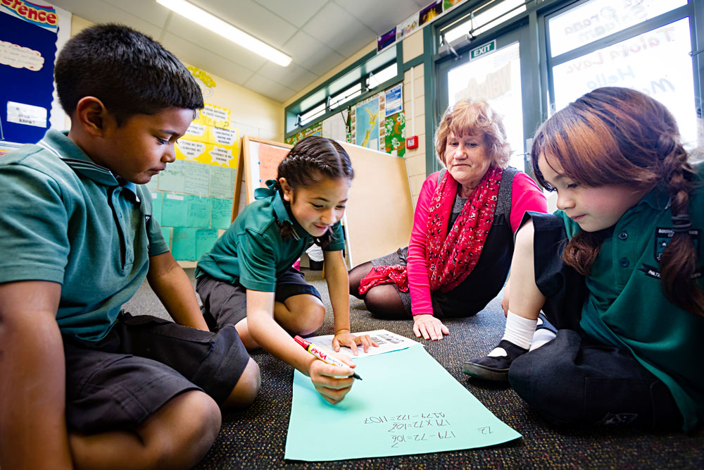 Associate Professor Bobbie Hunter with keen young learners at Southern Cross: “I think a lot of Pasifika and Maori students are doing really badly because nobody ever hears them.”