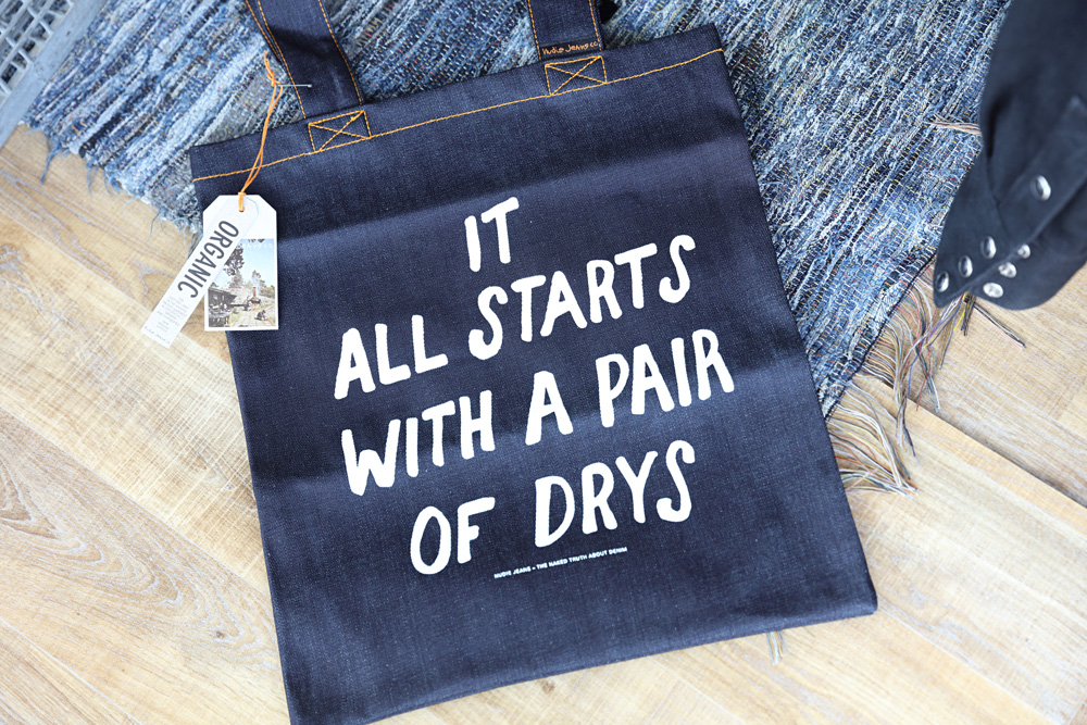 A tote bag reveals Nudie’s origins when it started out producing ‘dry’ jeans. 