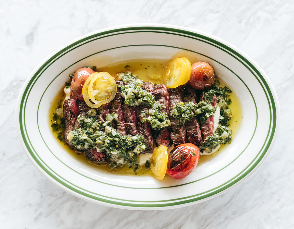 Woodfired bavette steak, salsa verde, smoked beef fat tomato, horseradish. Photo: Josh Griggs