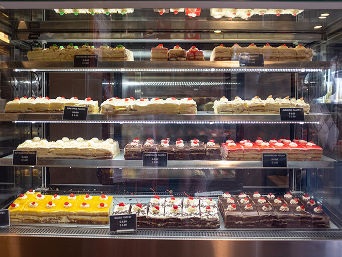 A cabinet full of cakes.